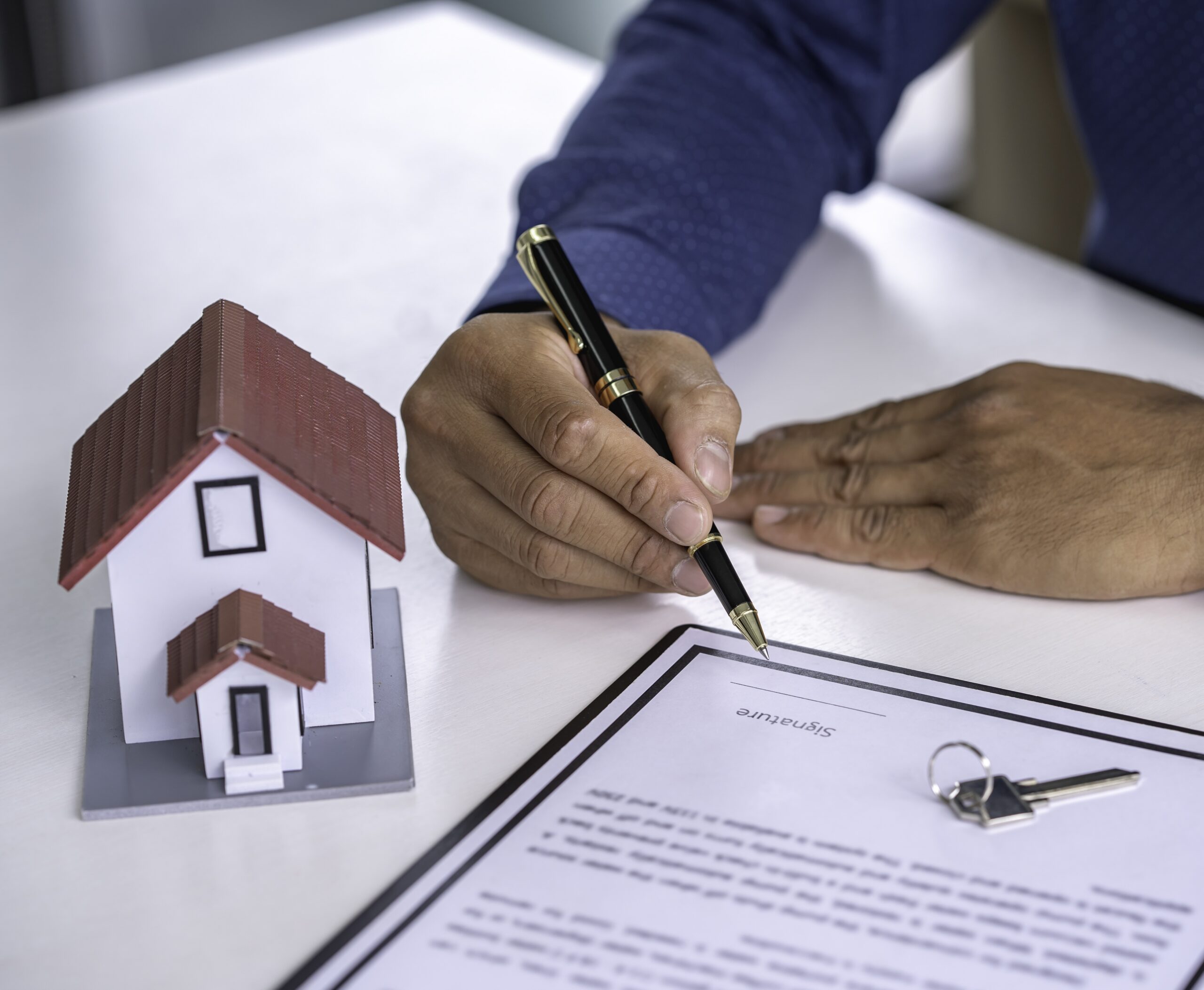 Businessman signing a document or application form in a folder, Businessmen hand's pointing where to sign a contract, legal papers or application form.